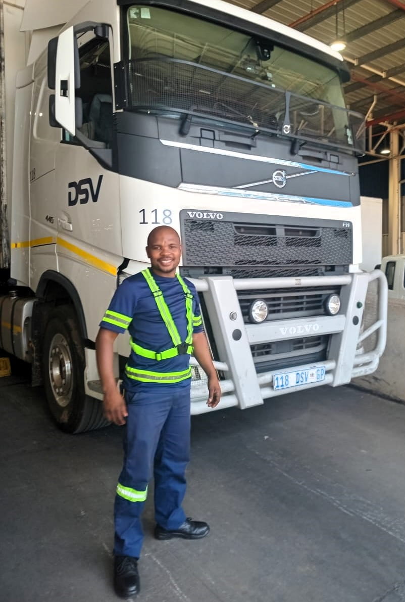 Sabelo proudly standing in front of his DSV truck
